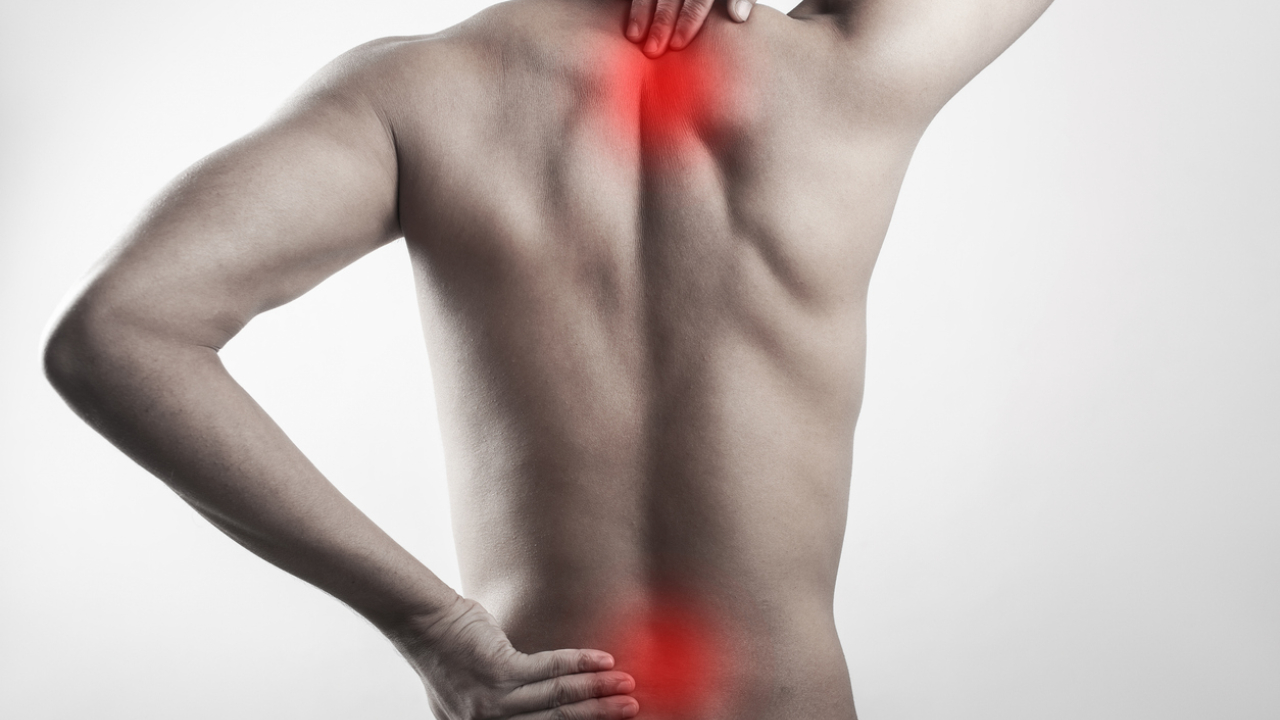 Person's back shown in profile with red highlight at neck and lower back to indicate pain or discomfort